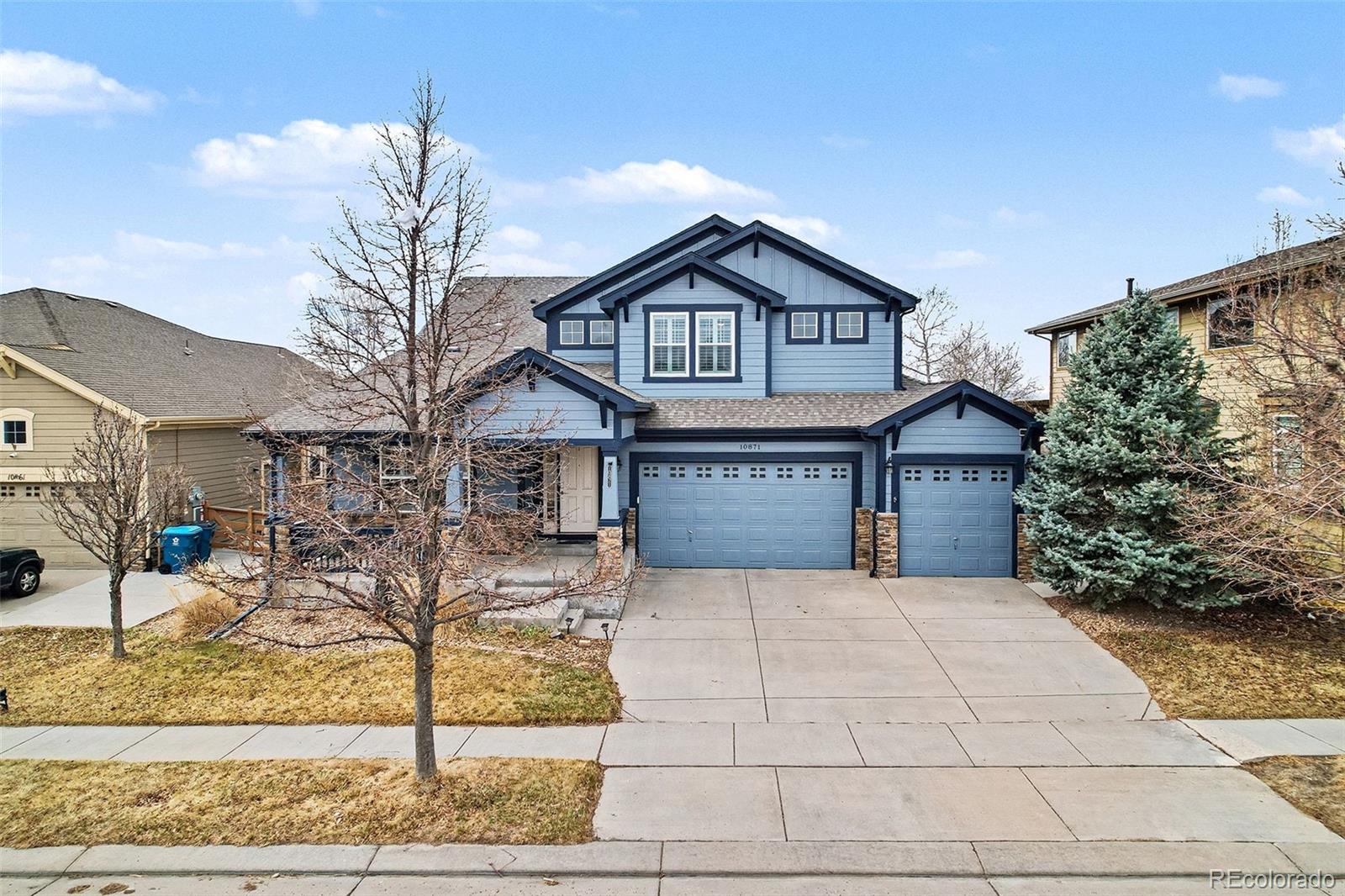 10871 Chambers Way Commerce City, CO 80022 - Photo 2 of 50 a front view of a house with garden
