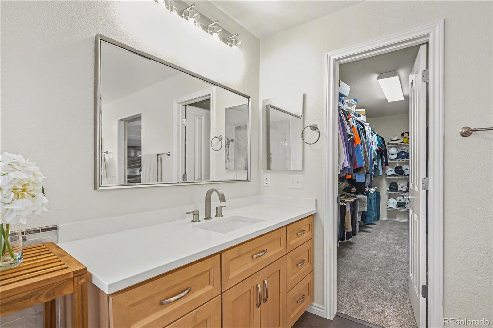 10871 Chambers Way Commerce City, CO 80022 - Photo 22 of 50 a bathroom with a sink vanity and mirror
