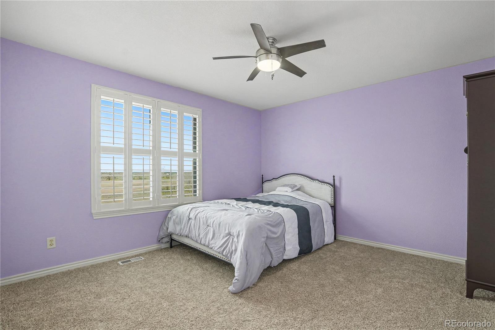 10871 Chambers Way Commerce City, CO 80022 - Photo 24 of 50 a spacious bedroom with a bed and a window
