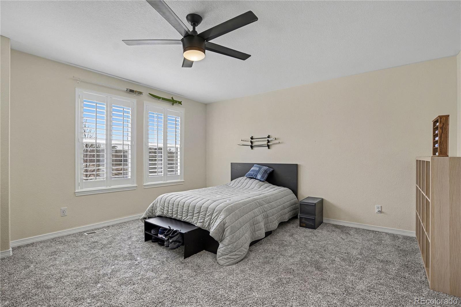 10871 Chambers Way Commerce City, CO 80022 - Photo 25 of 50 a bedroom with a bed and a window