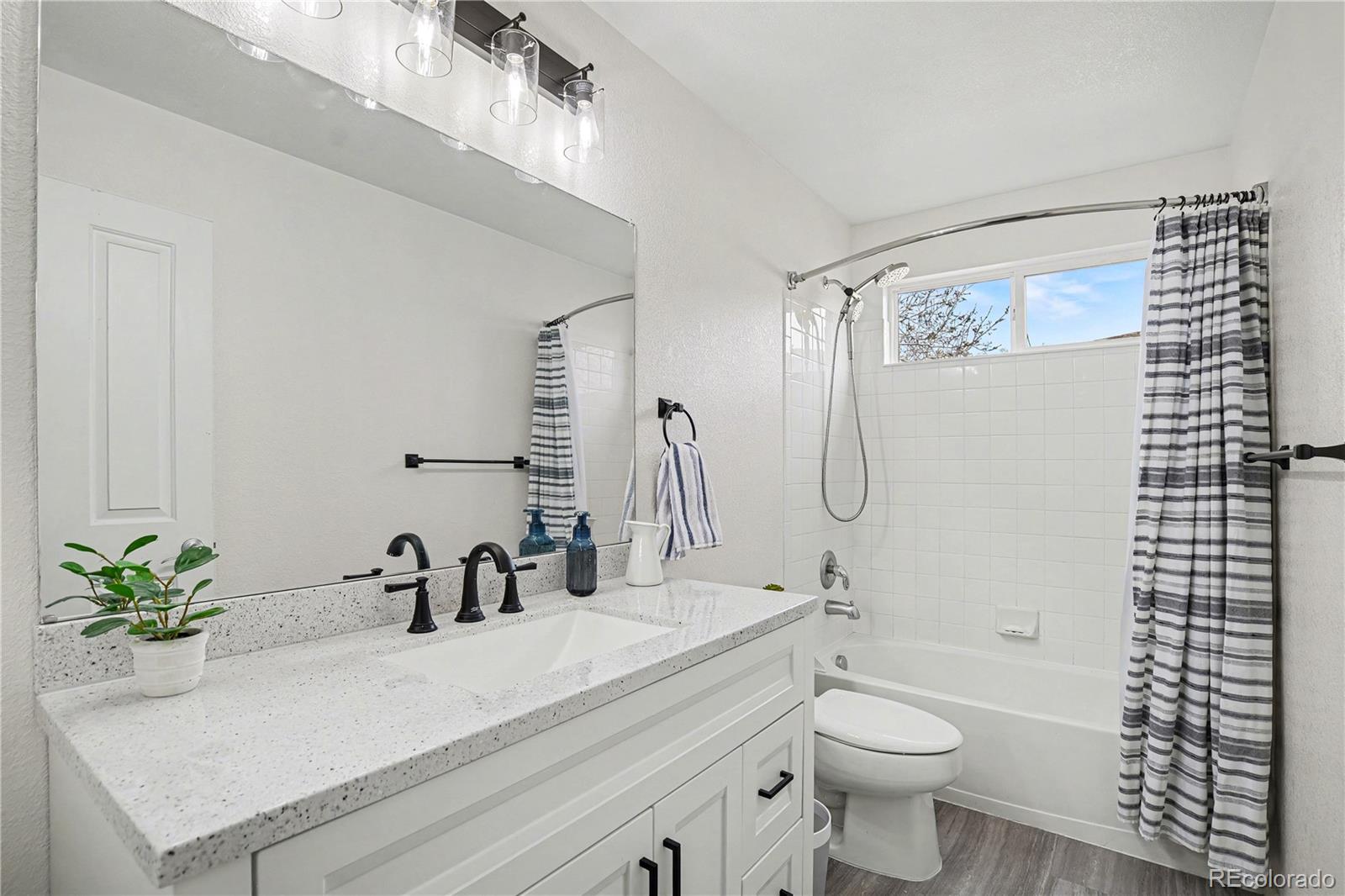 10871 Chambers Way Commerce City, CO 80022 - Photo 27 of 50 a bathroom with a sink a toilet and a mirror