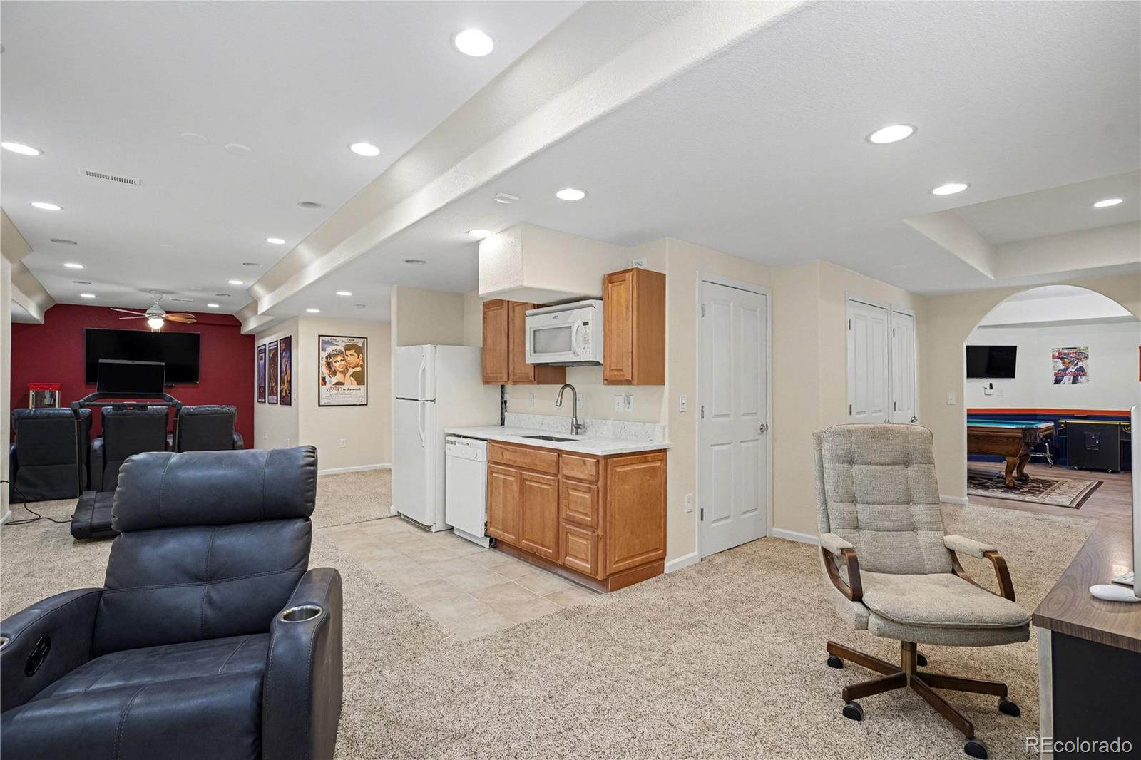 10871 Chambers Way Commerce City, CO 80022 - Photo 30 of 50 a living room with furniture kitchen view and a wooden floor