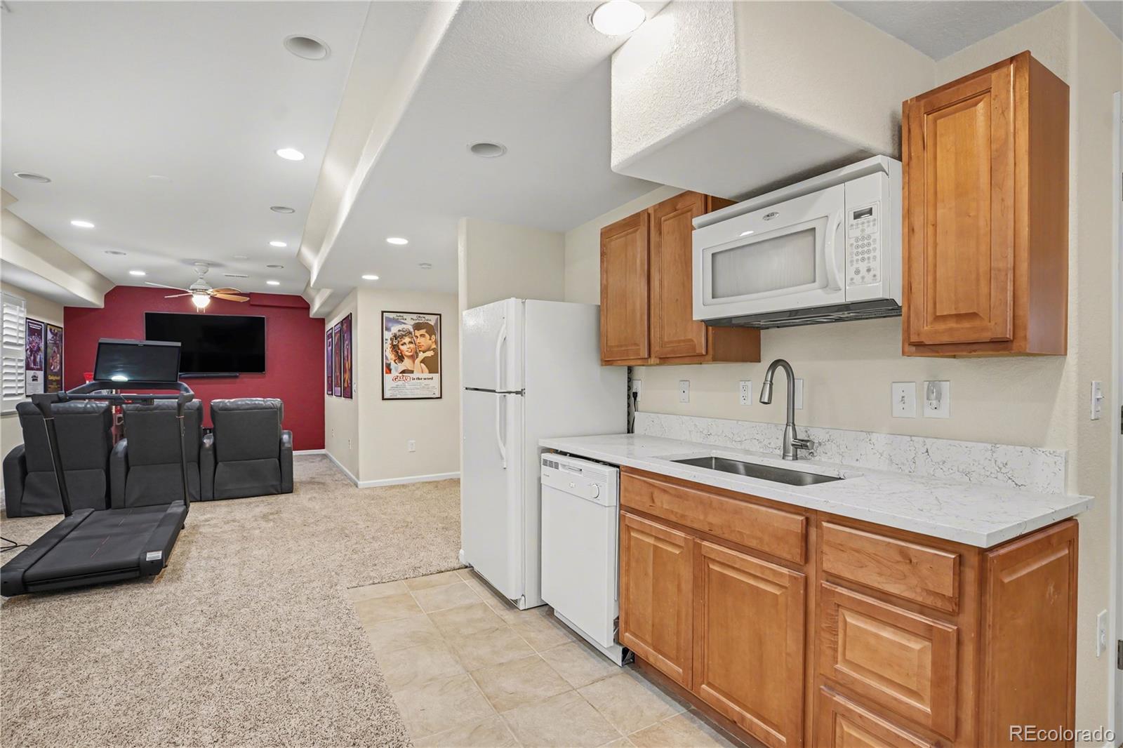 10871 Chambers Way Commerce City, CO 80022 - Photo 32 of 50 a kitchen with stainless steel appliances granite countertop a sink and cabinets