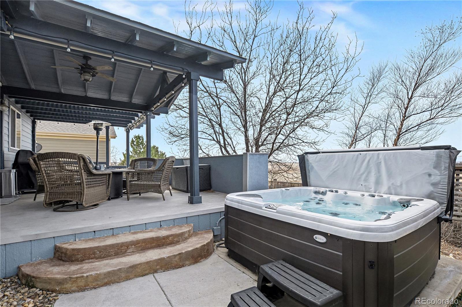 10871 Chambers Way Commerce City, CO 80022 - Photo 39 of 50 a view of roof deck with table and chairs a barbeque