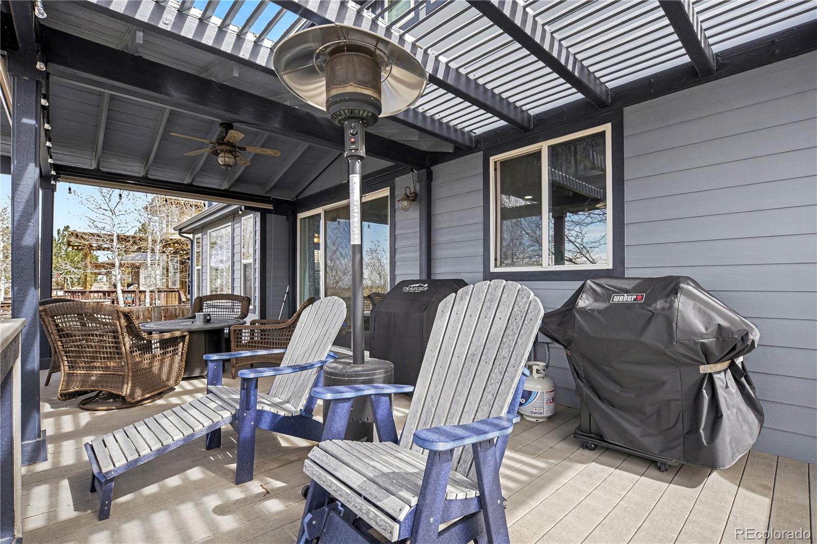 10871 Chambers Way Commerce City, CO 80022 - Photo 41 of 50 a view of a patio with table and chairs with wooden floor and fence
