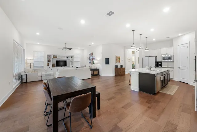 a living room with furniture a table and a flat screen tv