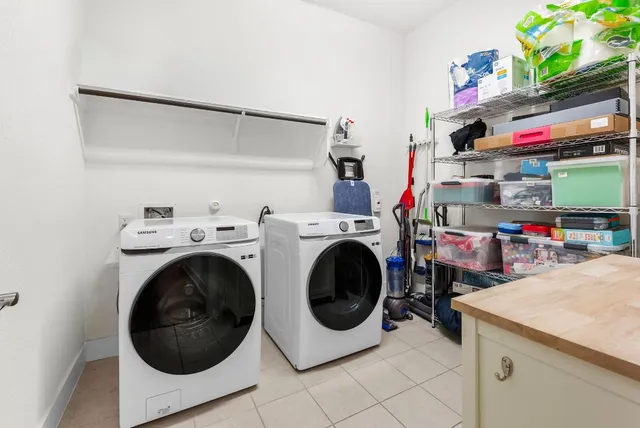 a bedroom with furniture a flat screen tv and a window