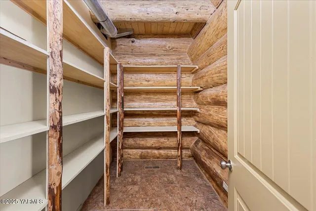 a view of walk in closet with empty racks