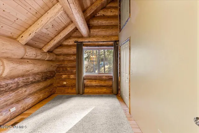 a view of room with wooden floor and windows