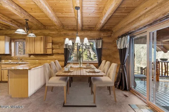 a dining hall with stainless steel appliances kitchen island granite countertop a dining table and chairs