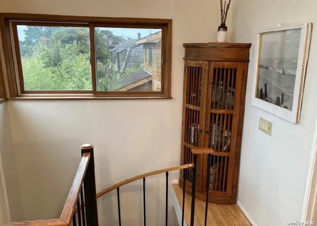 a view of a balcony with wooden floor and stairs