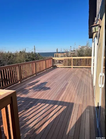 a view of balcony with wooden floor and fence