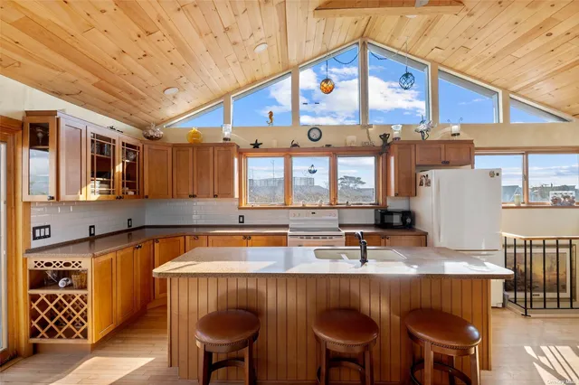 a kitchen with stainless steel appliances granite countertop a sink and a table