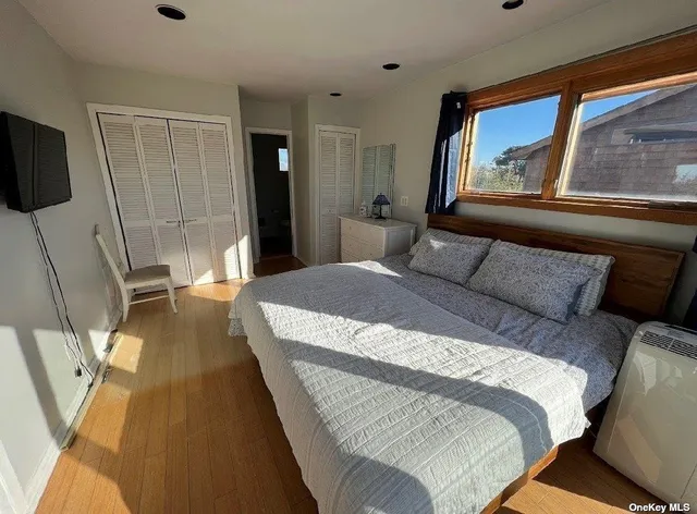 a bed sitting in a bedroom next to a window