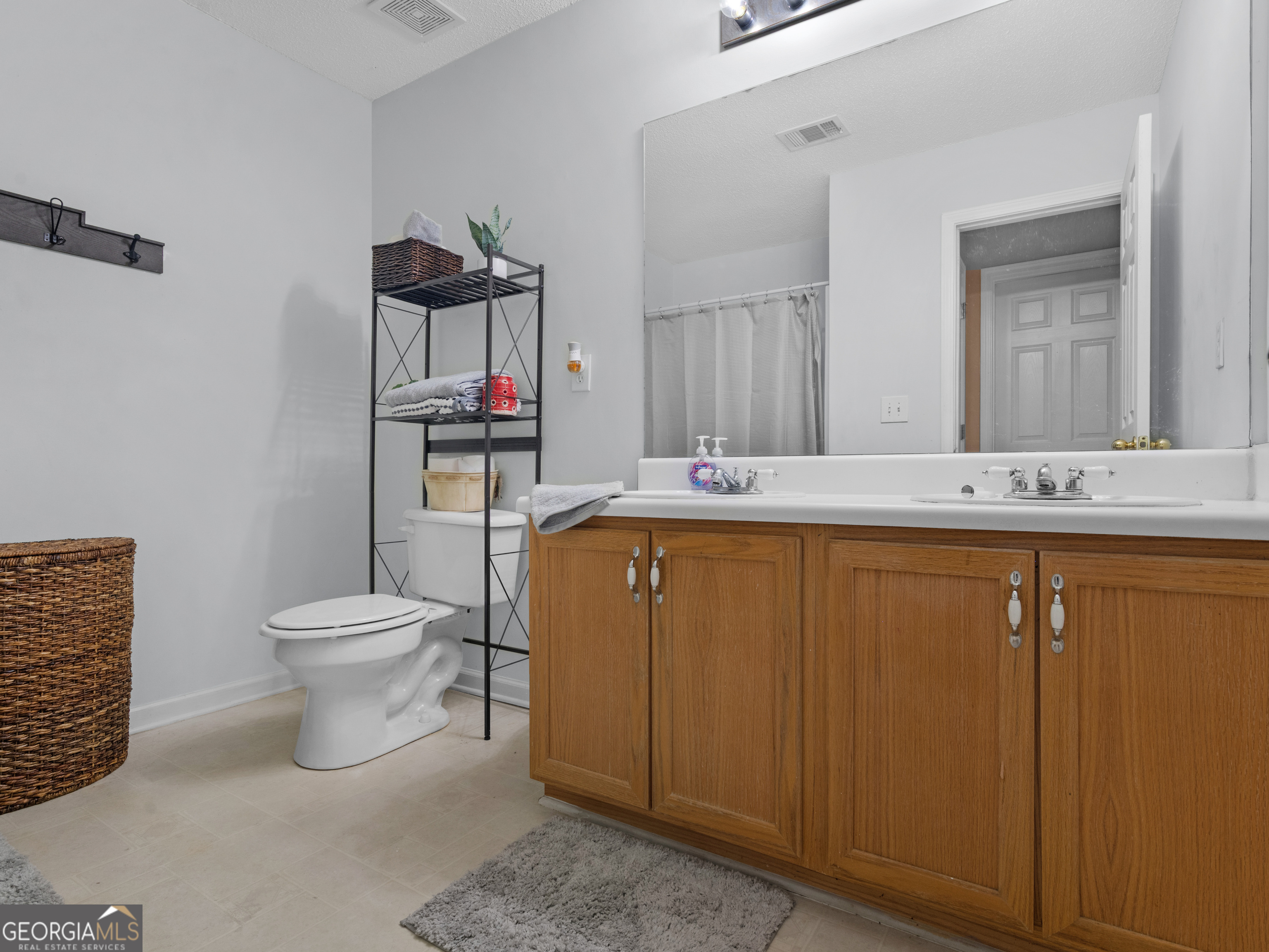3370 Waggoner Place Rex, GA 30273 - Photo 21 of 25 a bathroom with a toilet sink and mirror