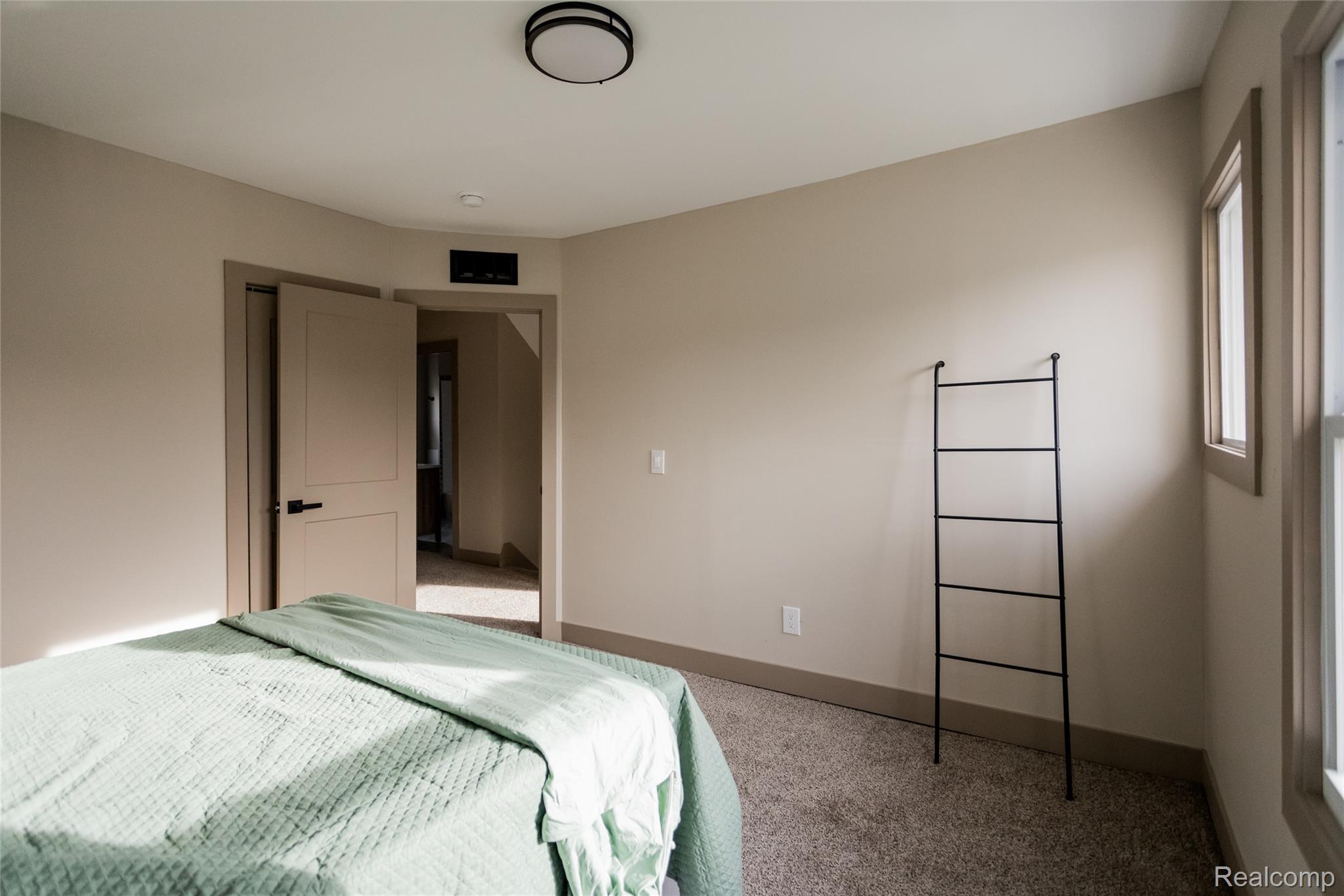 2630 Harding Street Detroit, MI 48214 - Photo 25 of 30 Carpeted room with neutral wall tones and a window featuring natural light