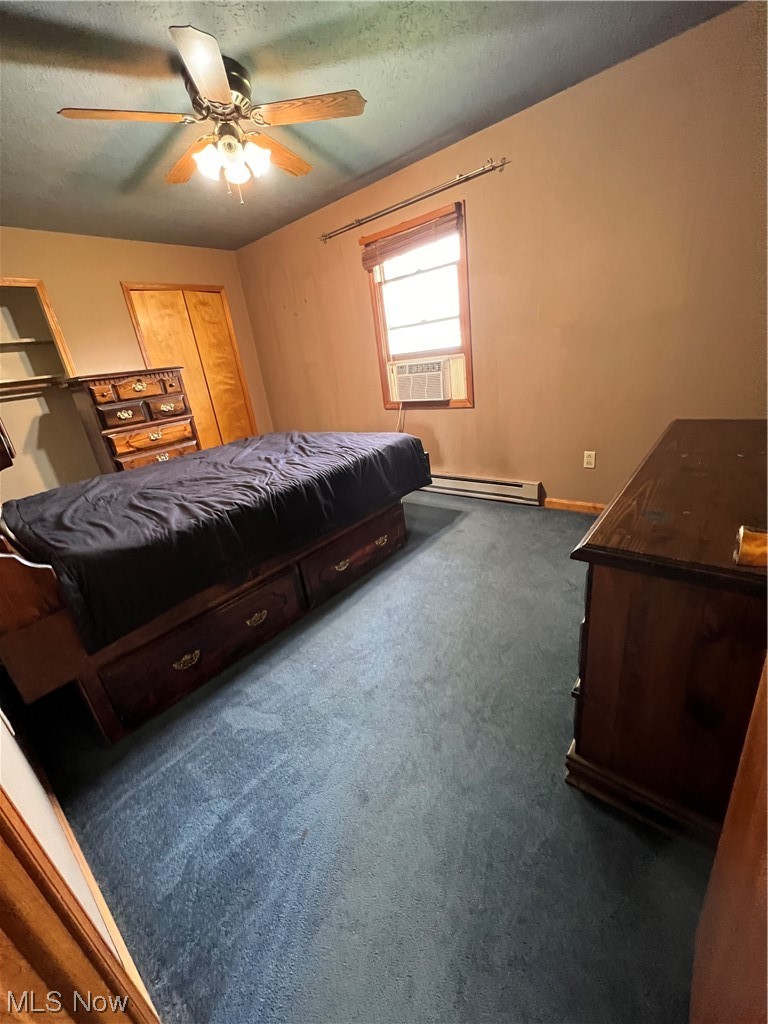 5435 Columbia Road Medina, OH 44256 - Photo 18 of 30 Carpeted bedroom with a baseboard heating unit, a textured ceiling, and ceiling fan