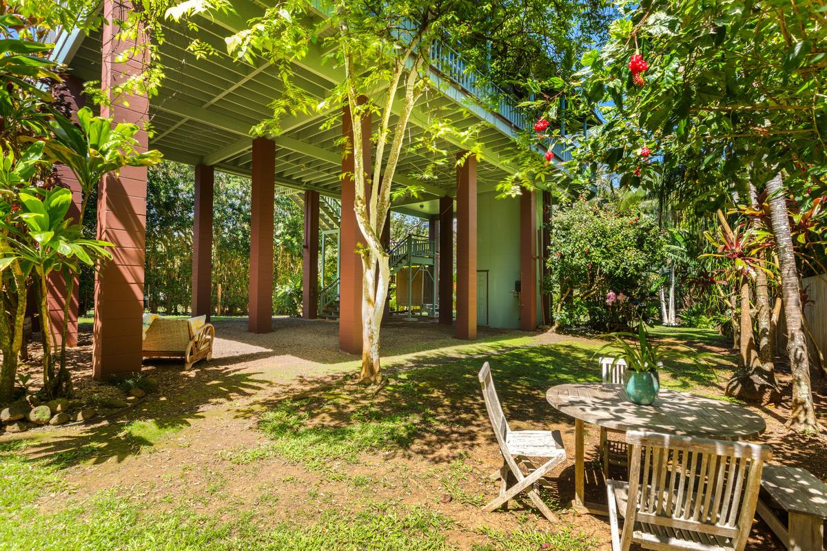 24 Off Moloaa Road Kilauea, HI 96754 - Photo 23 of 25 a backyard of a house with table and chairs