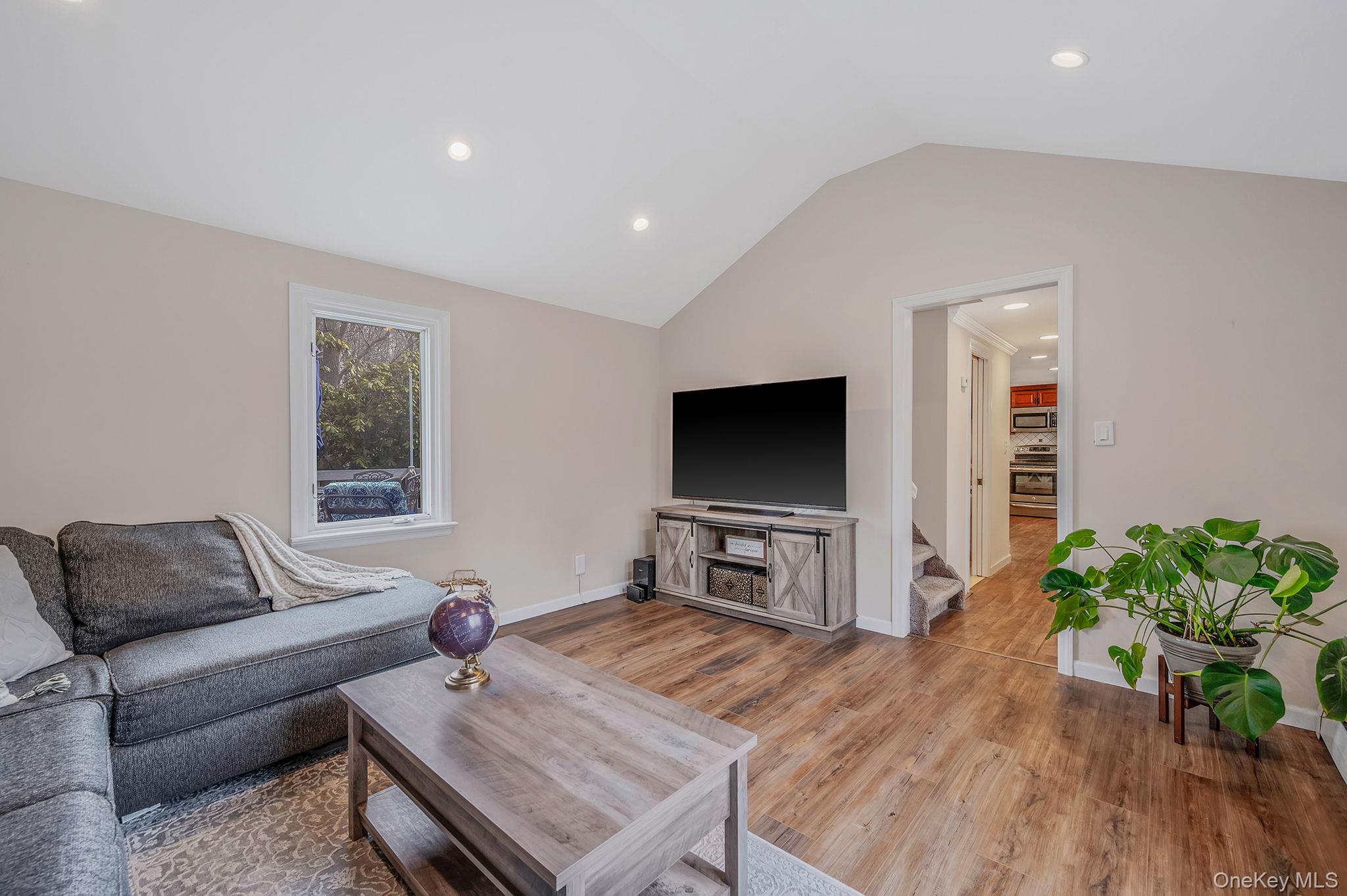 5 Valley Circle Miller Place, NY 11764 - Photo 11 of 38 a living room with furniture and a flat screen tv