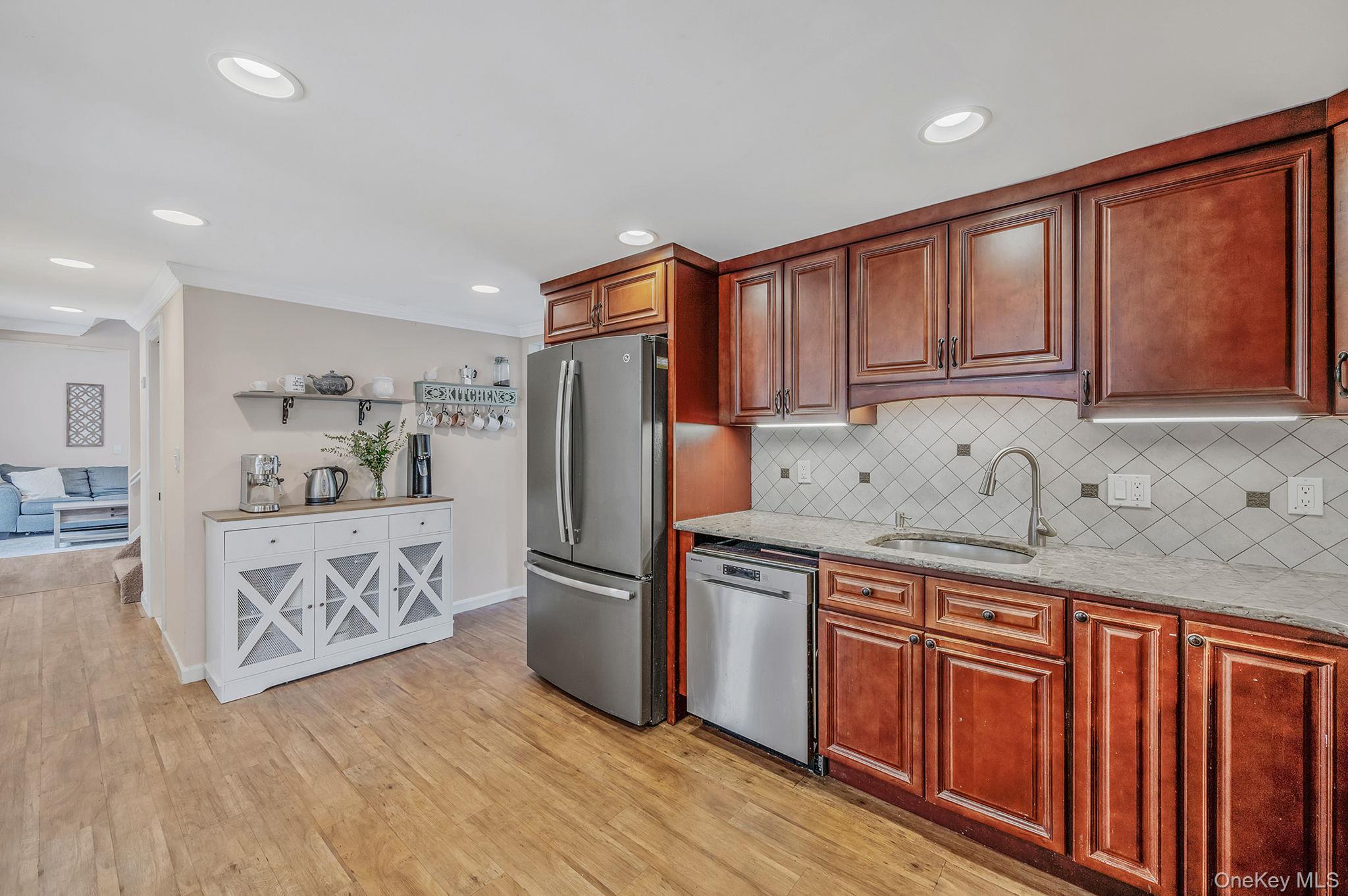 5 Valley Circle Miller Place, NY 11764 - Photo 14 of 38 a kitchen with stainless steel appliances granite countertop a refrigerator sink and cabinets