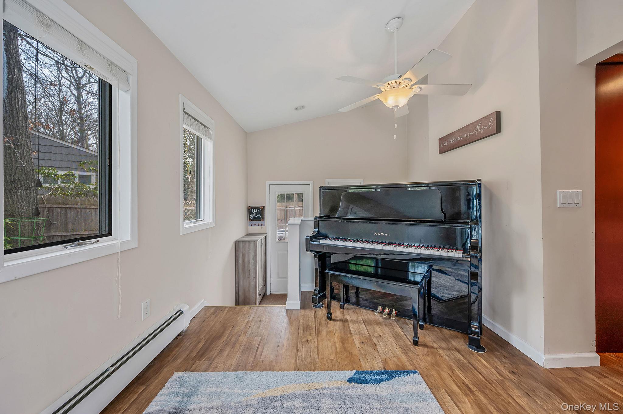 5 Valley Circle Miller Place, NY 11764 - Photo 16 of 38 a living room with furniture and a wooden floor