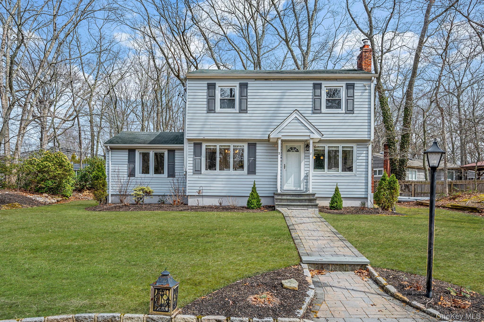 5 Valley Circle Miller Place, NY 11764 - Photo 2 of 38 a front view of a house with a yard