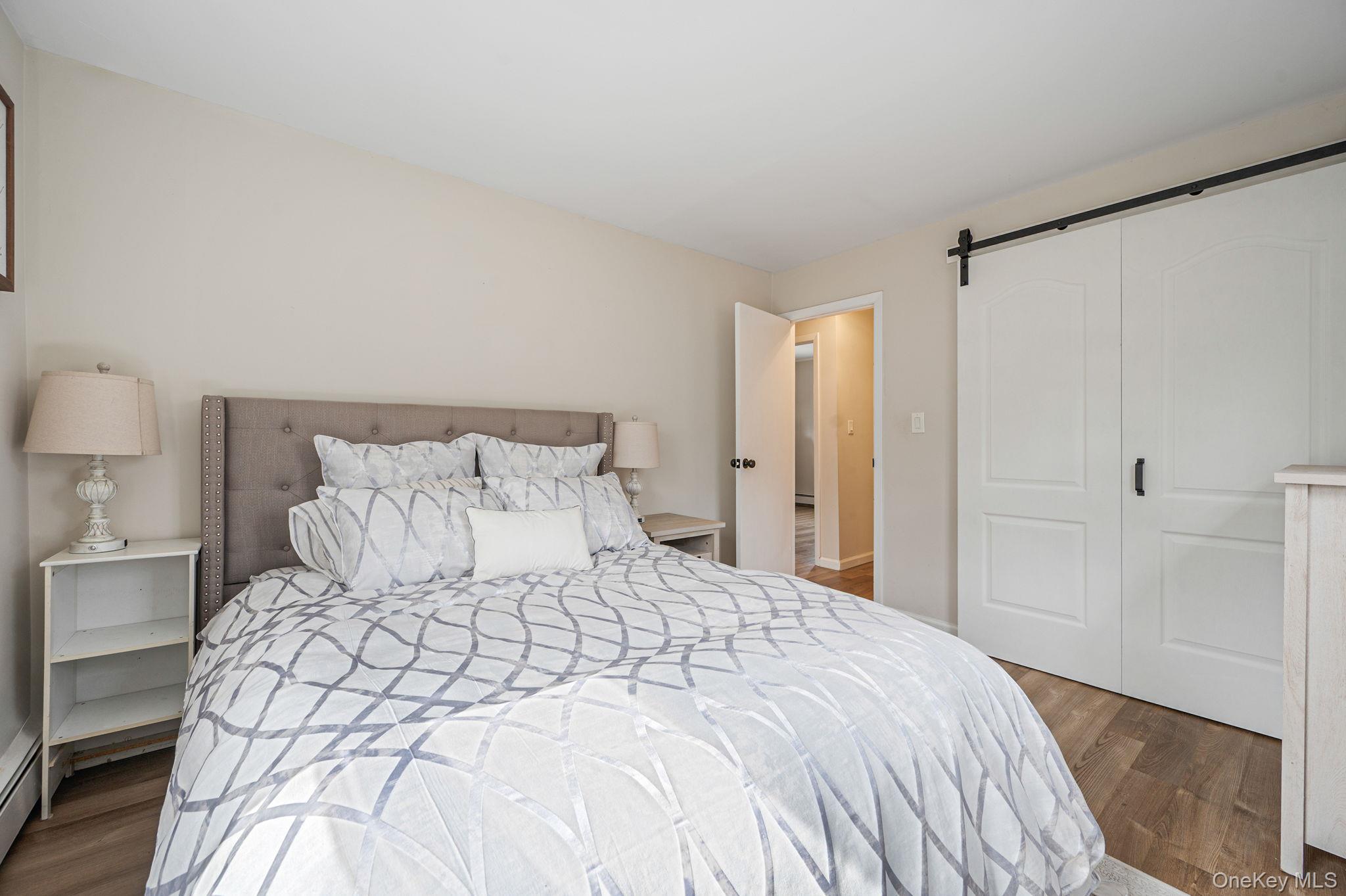 5 Valley Circle Miller Place, NY 11764 - Photo 20 of 38 a bedroom with a bed and a night stand