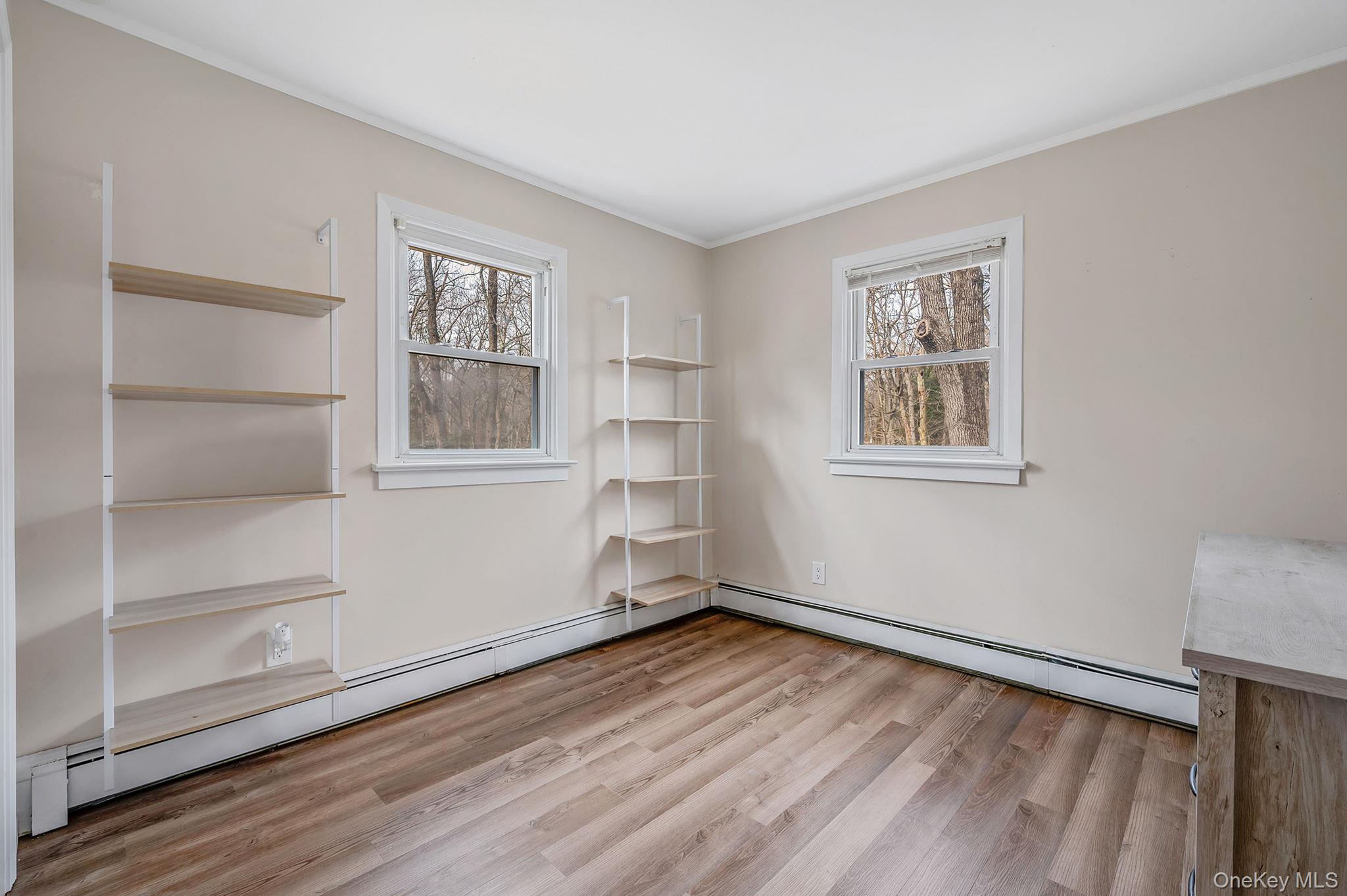 5 Valley Circle Miller Place, NY 11764 - Photo 23 of 38 a view of empty room with wooden floor and fan