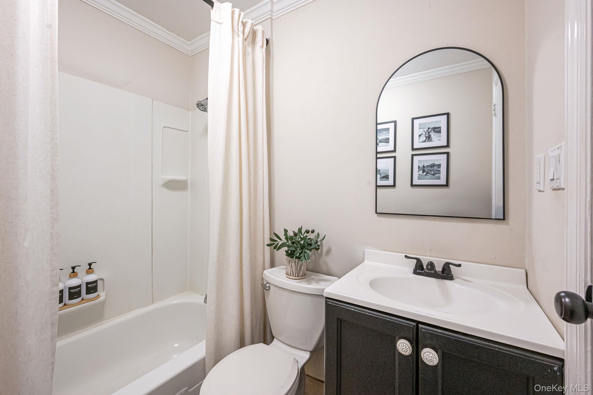 5 Valley Circle Miller Place, NY 11764 - Photo 25 of 38 a bathroom with a sink a toilet and shower