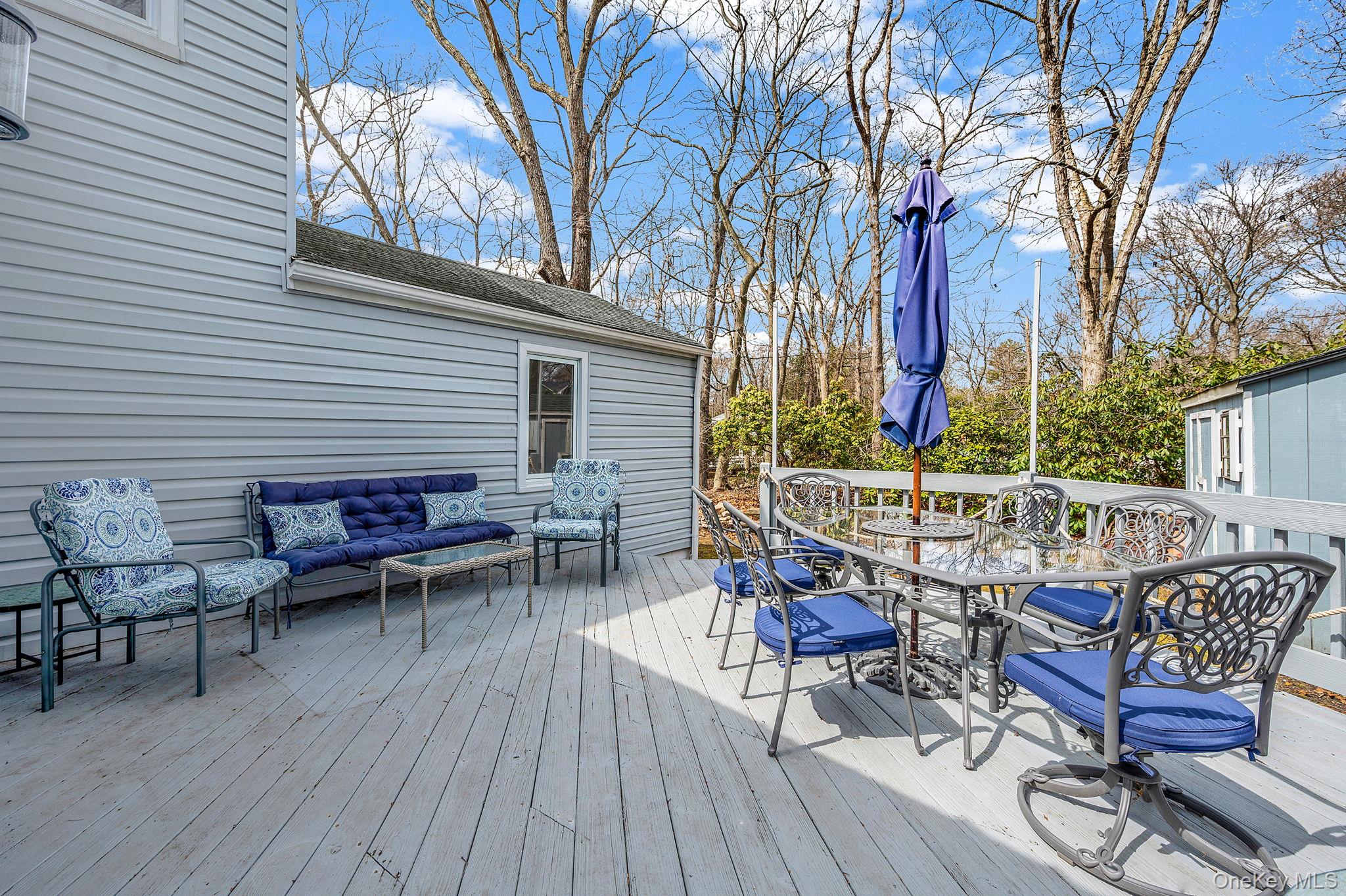 5 Valley Circle Miller Place, NY 11764 - Photo 28 of 38 a view of a chairs and table on the deck