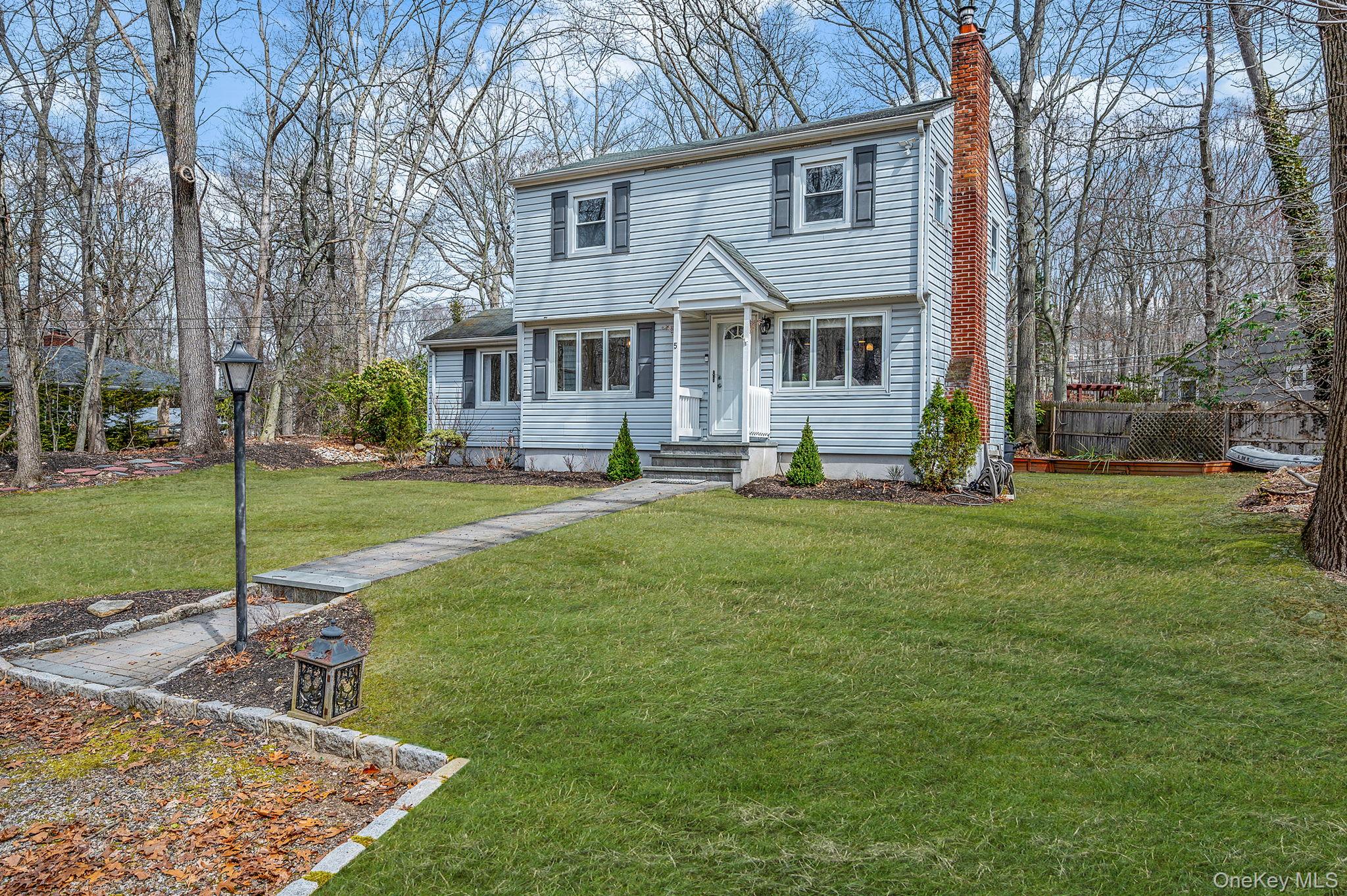 5 Valley Circle Miller Place, NY 11764 - Photo 3 of 38 a front view of house with yard and green space