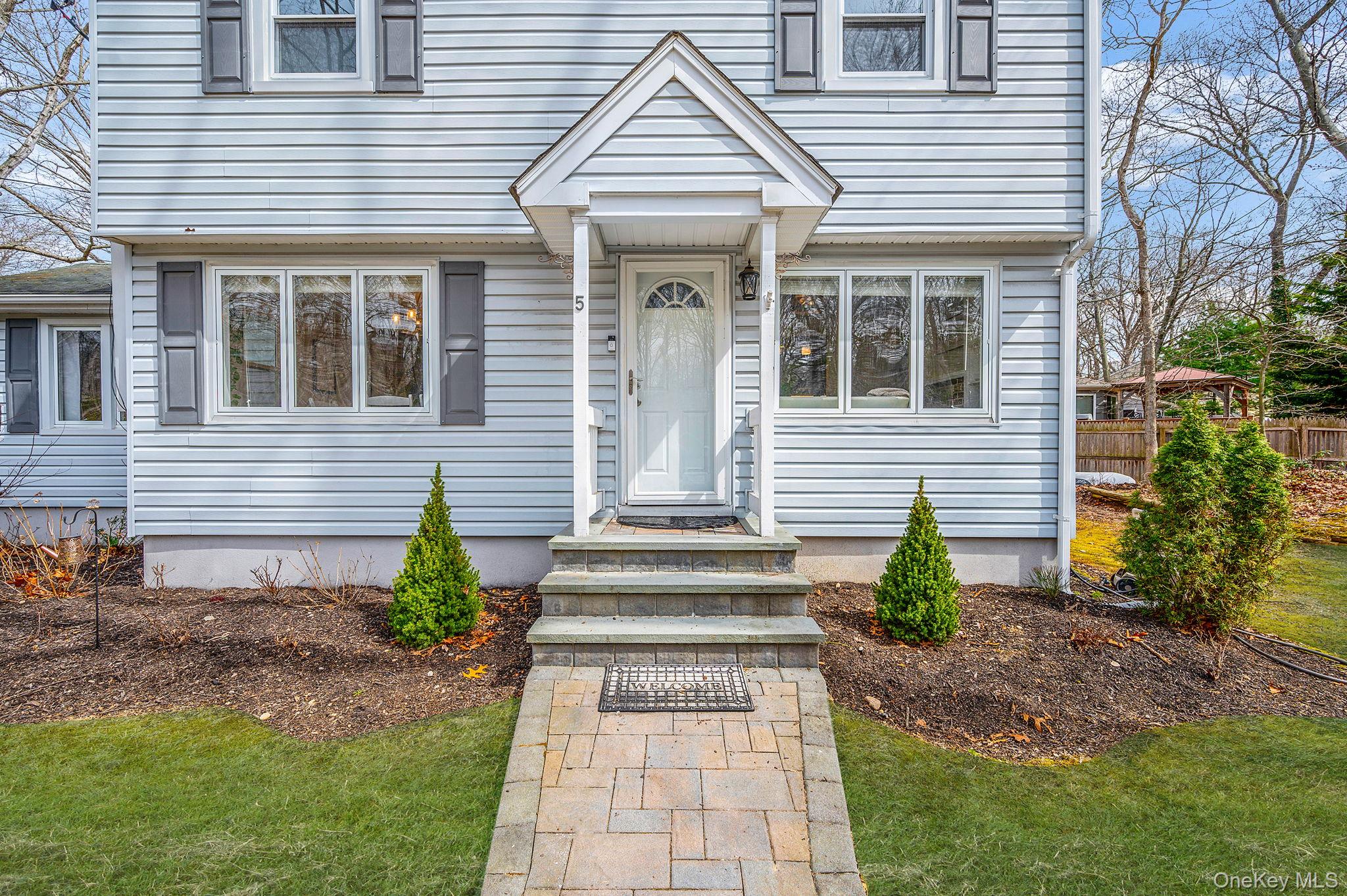 5 Valley Circle Miller Place, NY 11764 - Photo 5 of 38 a front view of a house with garden