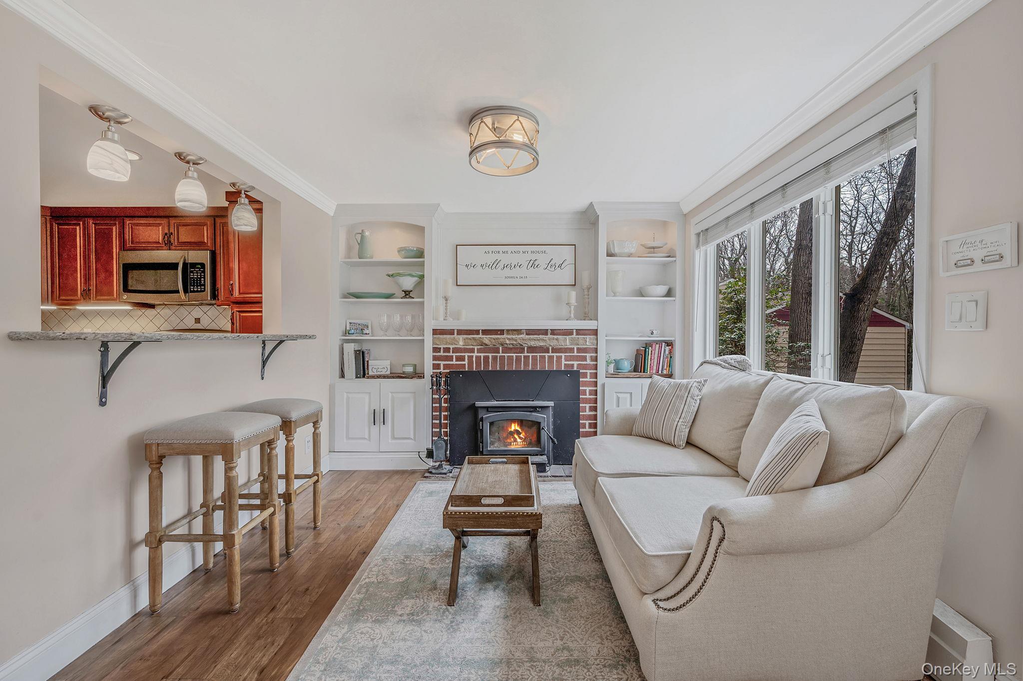 5 Valley Circle Miller Place, NY 11764 - Photo 6 of 38 a living room with furniture a fireplace and a flat screen tv