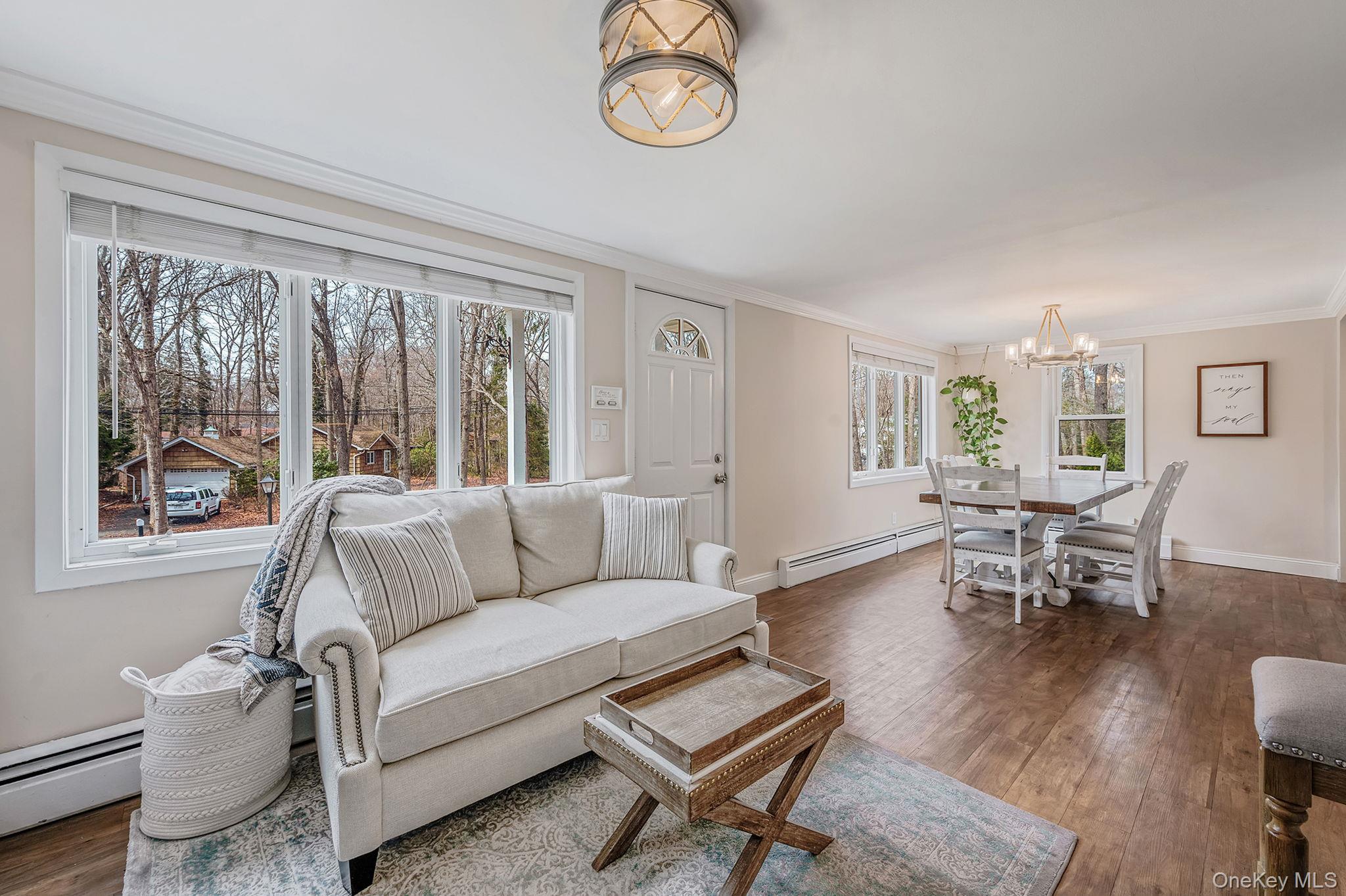 5 Valley Circle Miller Place, NY 11764 - Photo 7 of 38 a living room with furniture a table and a window