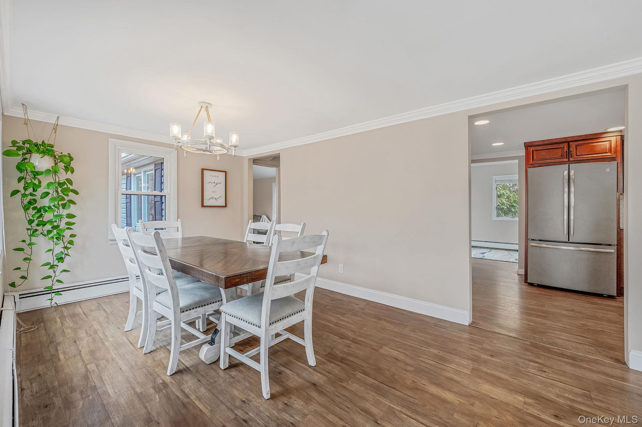 5 Valley Circle Miller Place, NY 11764 - Photo 8 of 38 a view of a dining room with furniture and chandelier
