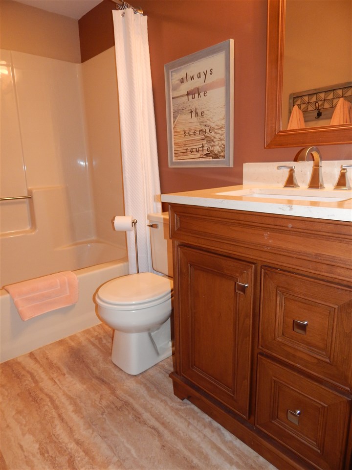 10001 Atwood Road Roscoe, IL 61073 - Photo 17 of 24 a bathroom with a toilet a sink and bathtub