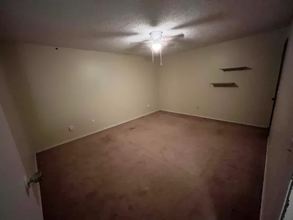 an empty room with a fan