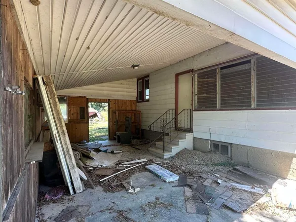 a view of a house with snow on the side of the road