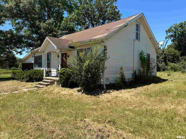 a view of backyard of house with green space