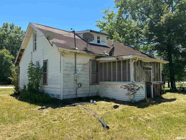 a view of a house with a yard covered in snow