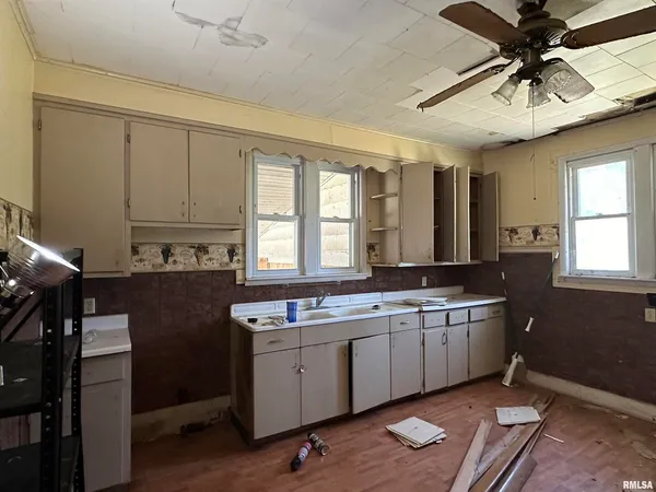 a kitchen with a sink appliances and cabinets
