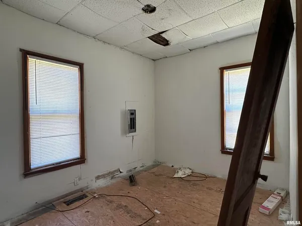 a view of a room with window and hardwood floor