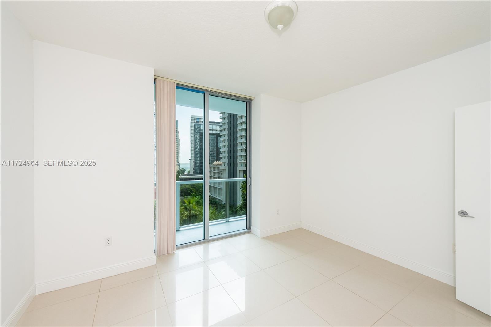 79 Southwest 12th Street, Unit 1107S Miami, FL 33130 - Photo 9 of 26 a view of an empty room with glass door