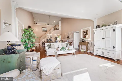 a living room with furniture and a chandelier