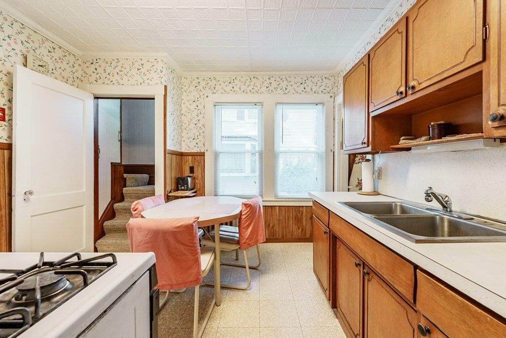 73 Sunapee Street Springfield, MA 01108 - Photo 15 of 40 a kitchen with stainless steel appliances granite countertop a sink and a stove