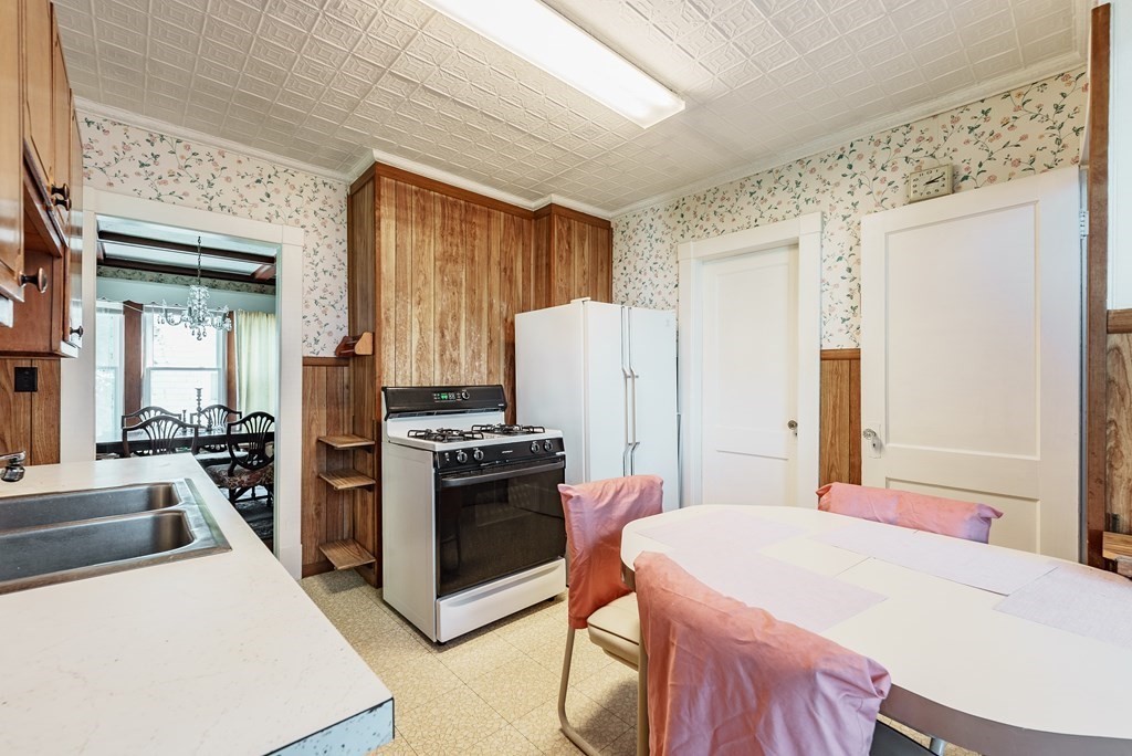 73 Sunapee Street Springfield, MA 01108 - Photo 17 of 40 a kitchen with a stove a refrigerator and a stove top oven