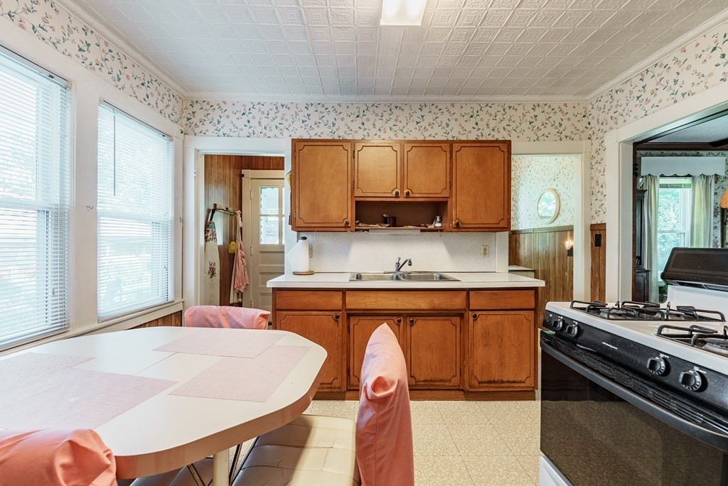 73 Sunapee Street Springfield, MA 01108 - Photo 18 of 40 a kitchen with stainless steel appliances granite countertop a stove a sink dishwasher and cabinets
