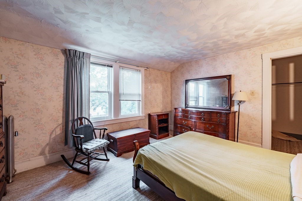 73 Sunapee Street Springfield, MA 01108 - Photo 21 of 40 a bedroom with a bed and wooden floor