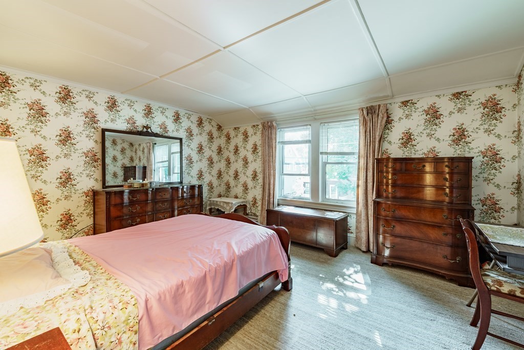73 Sunapee Street Springfield, MA 01108 - Photo 26 of 40 a spacious bedroom with a bed and a dresser next to a window