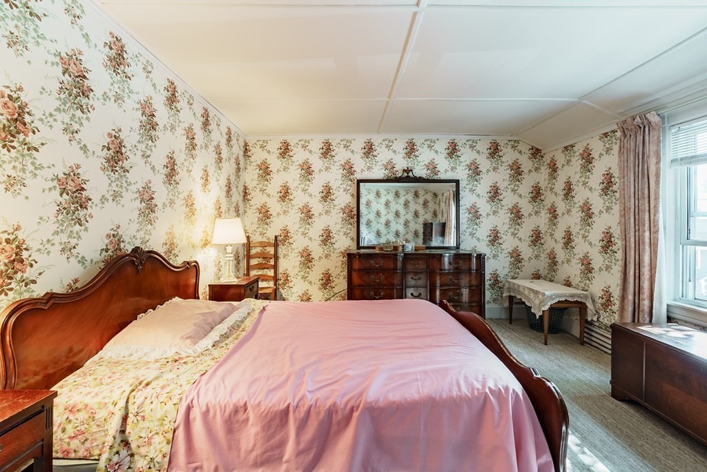 73 Sunapee Street Springfield, MA 01108 - Photo 27 of 40 a bedroom with a bed and a chandelier
